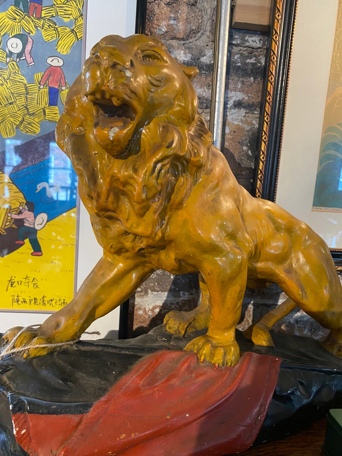 A stunning glazed chalk sculpture of a lion on a plinth