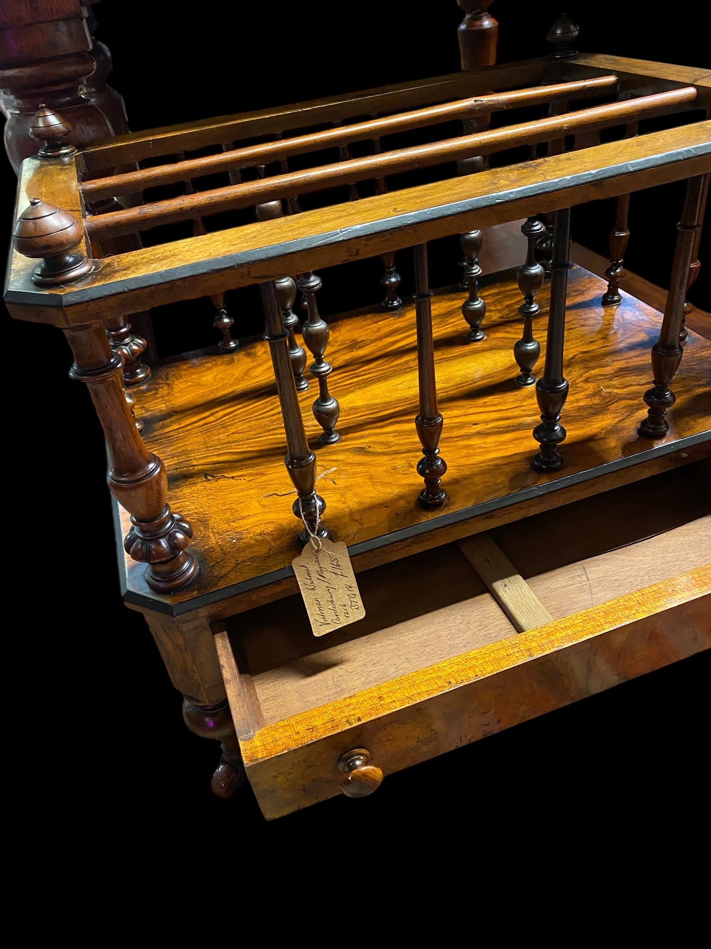 Late Victorian walnut Canterbury on brass casters and single drawer