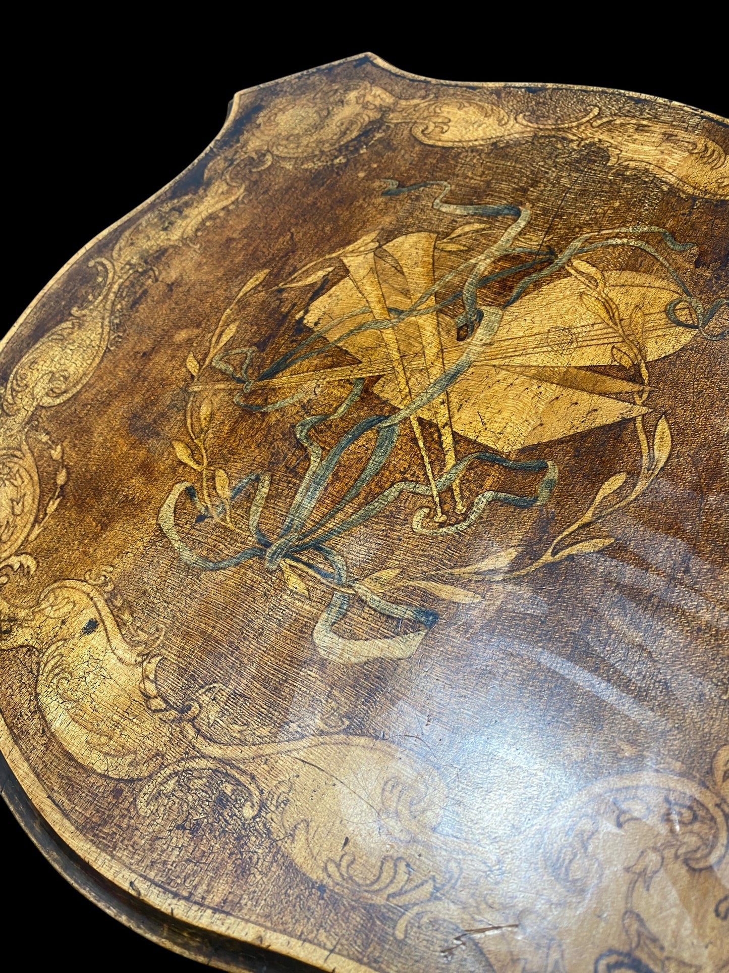 Early 1900's two tier side table painted with Musical instruments, wreath, ribbon and ornate design border