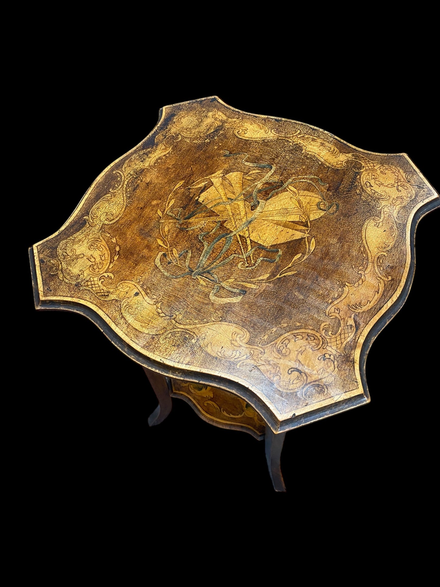 Early 1900's two tier side table painted with Musical instruments, wreath, ribbon and ornate design border
