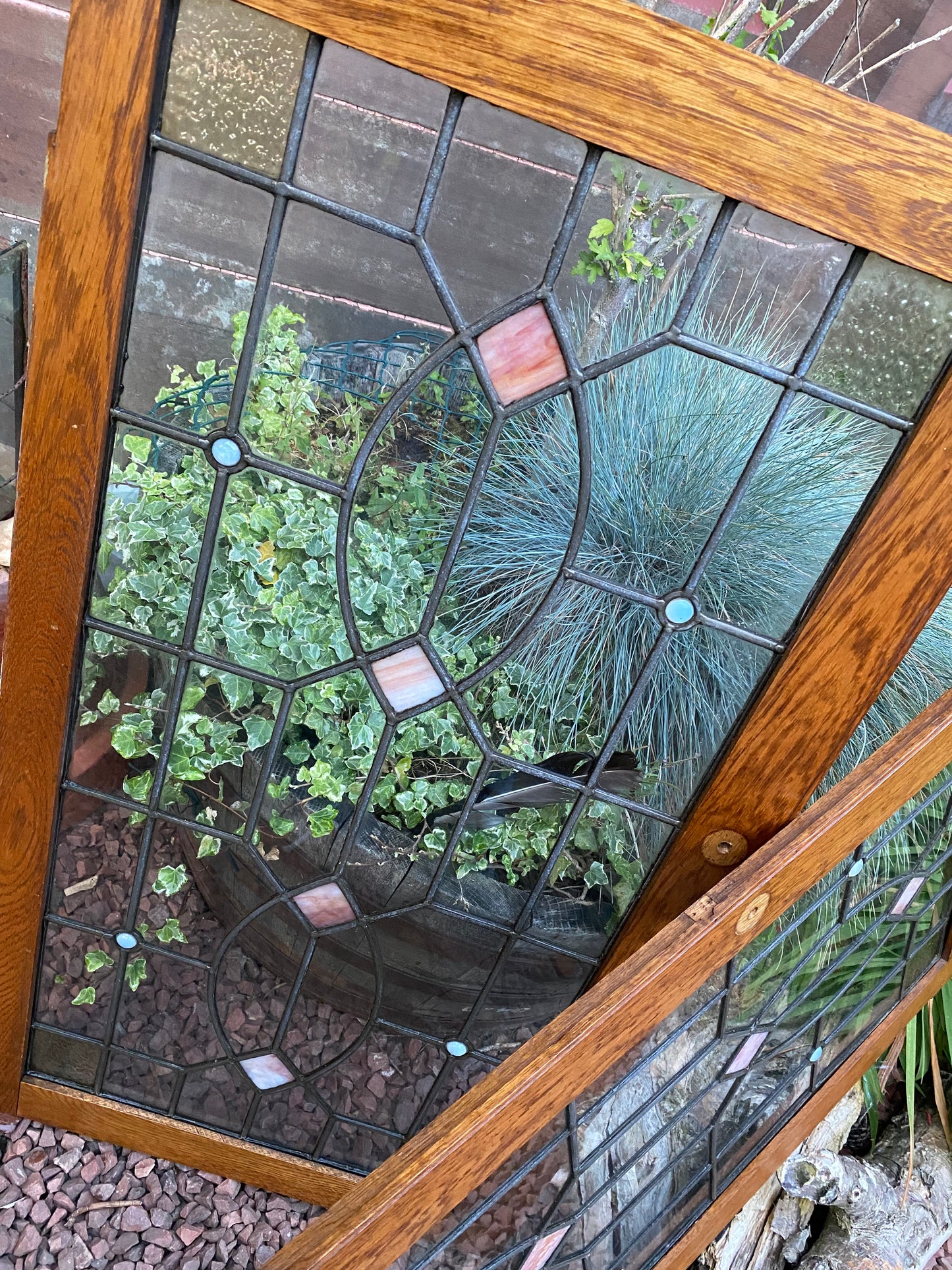 A pair of oak framed leaded stained glass panels circa 1900’s
