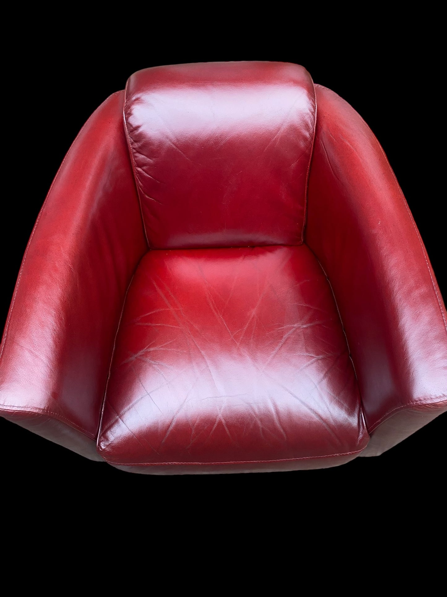 A stunning red leather vintage club chair