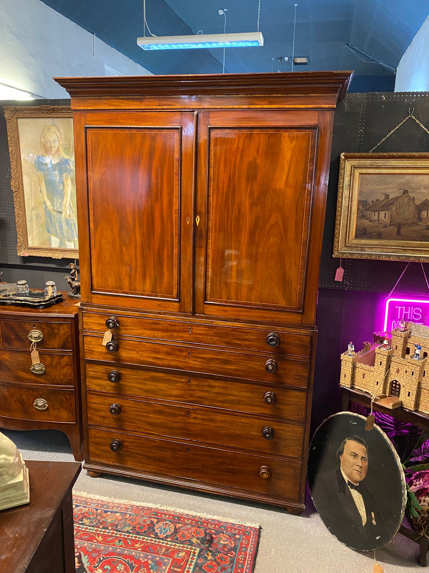 A 19th century mahogany linen press with integrated secretariat