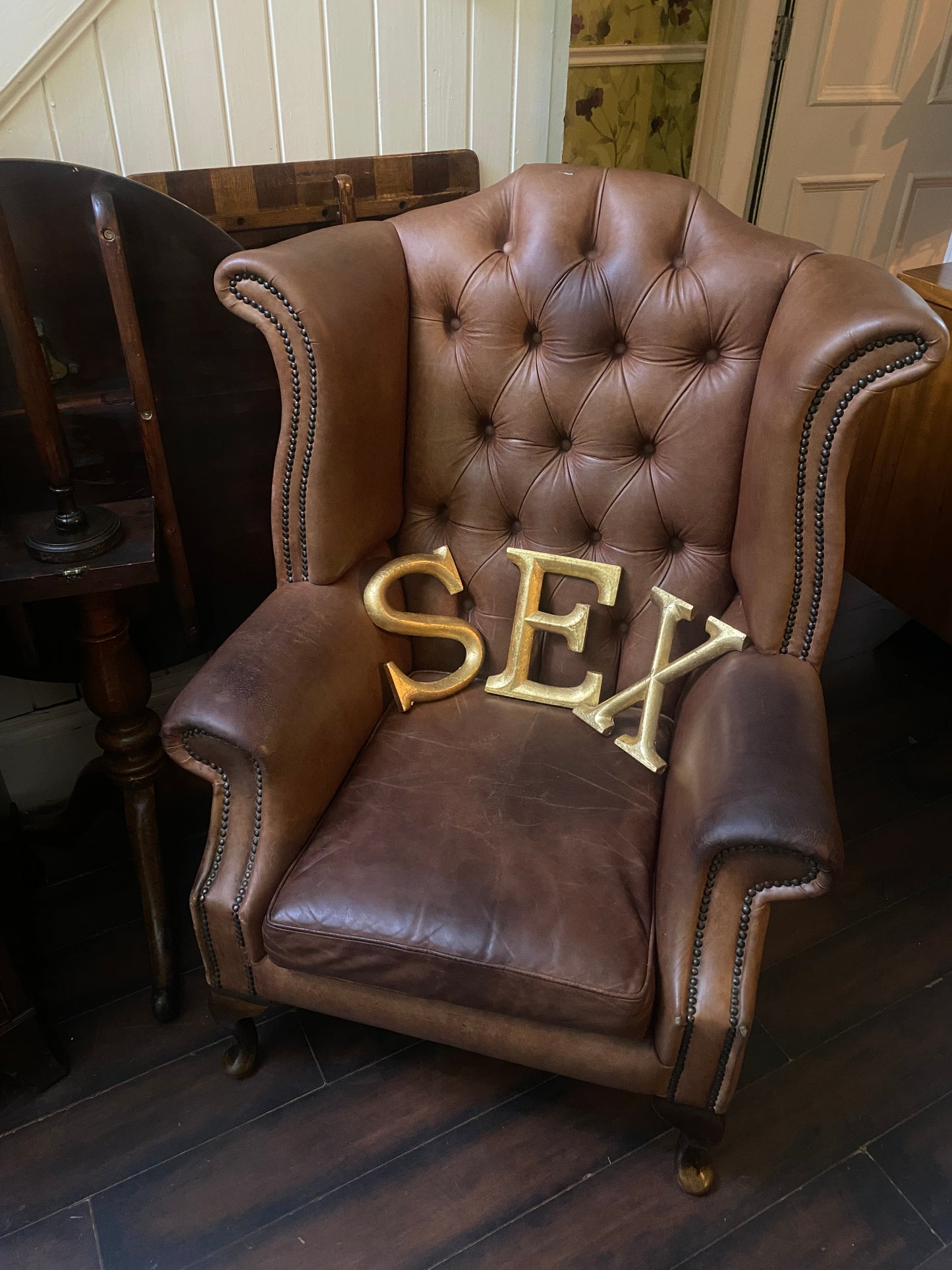 Vintage brown leather wing back armchair with stud detail and raised on front cabriole, queen Anne style supports