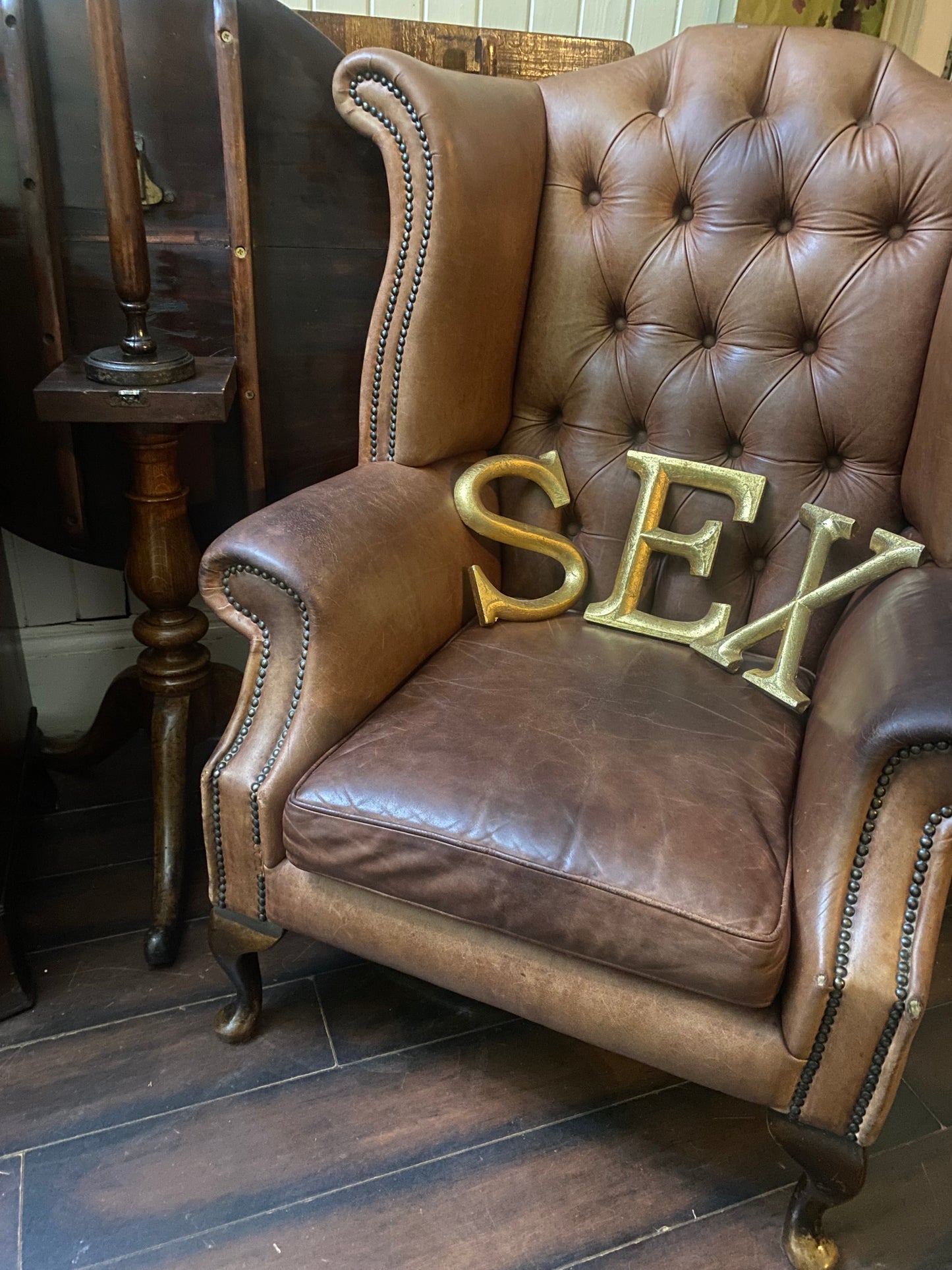 Vintage brown leather wing back armchair with stud detail and raised on front cabriole, queen Anne style supports