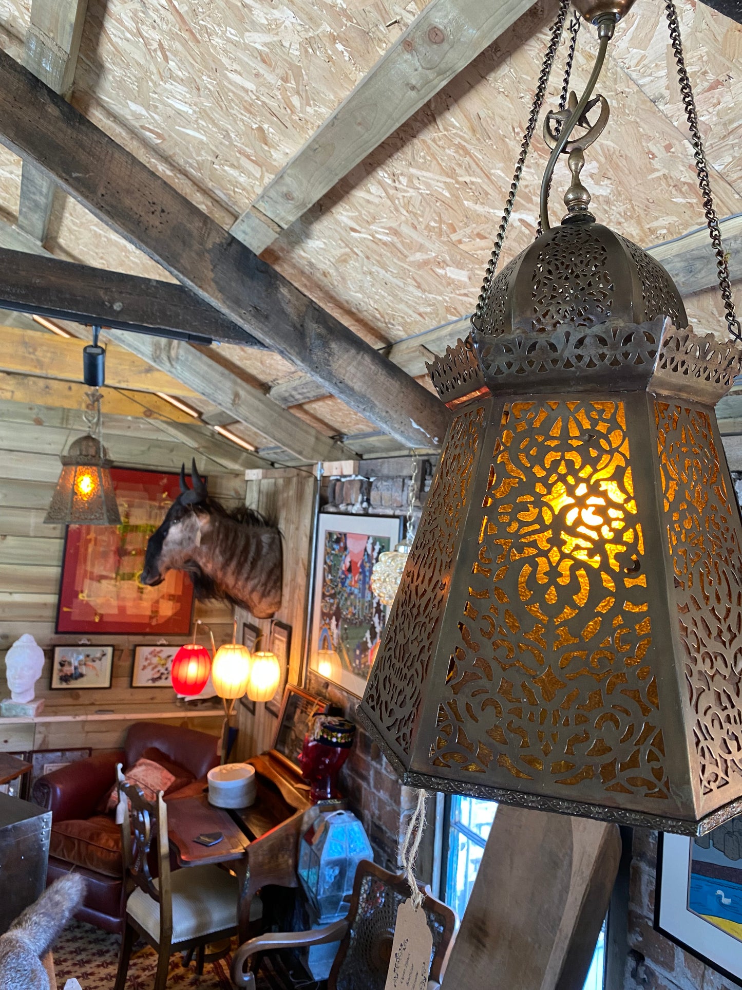 A pair of Moroccan brass lanterns with amber glass insets