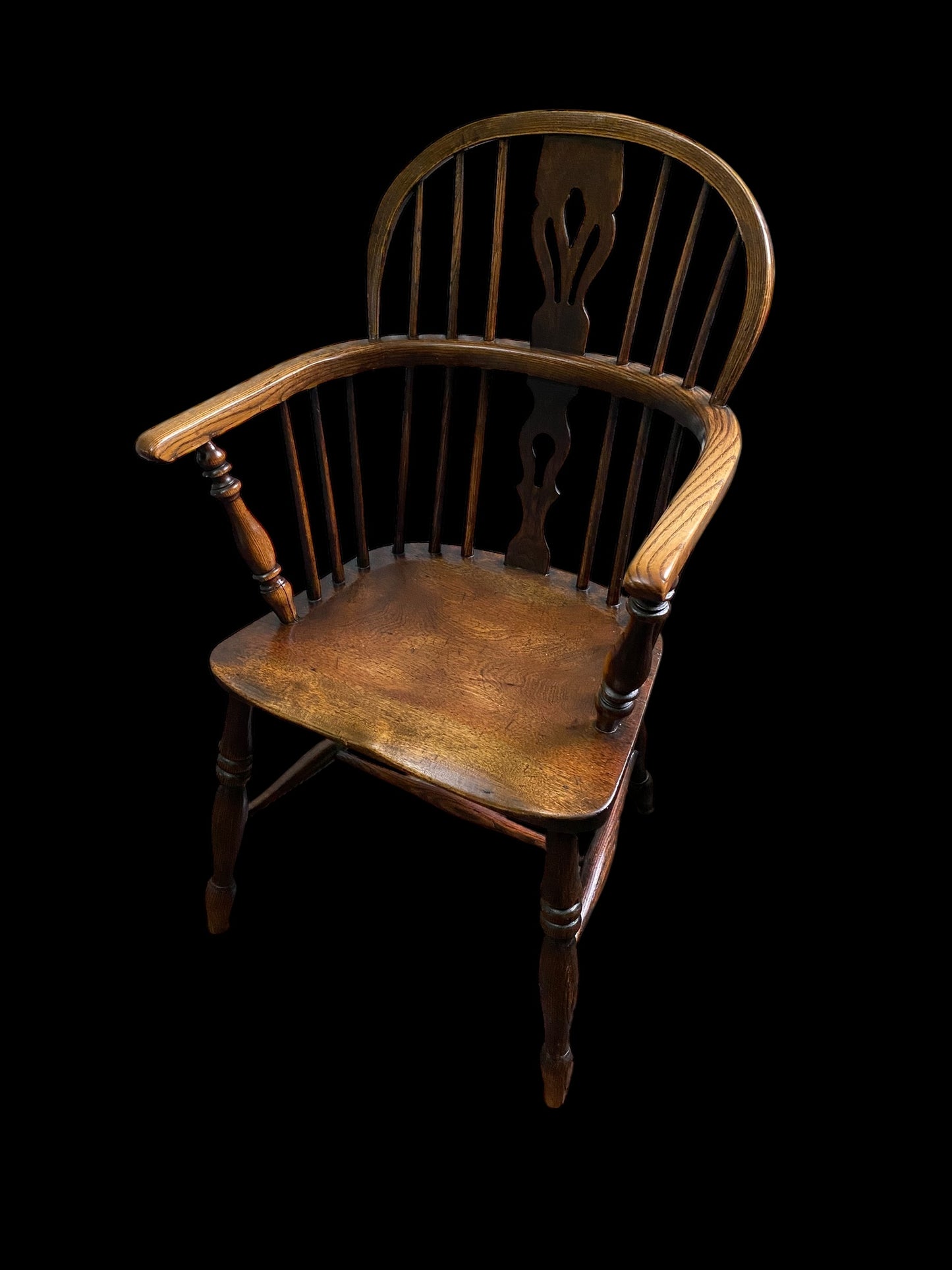 An early Victorian Ash & Elm comb back Windsor chair with carved splat