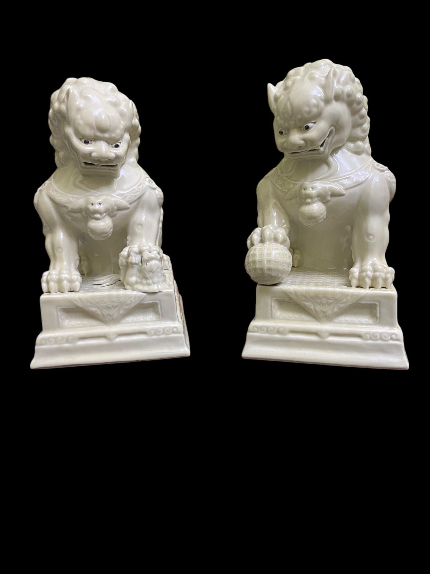 A pair of Chinese Dehua white porcelain Guardian Foo Dog statues