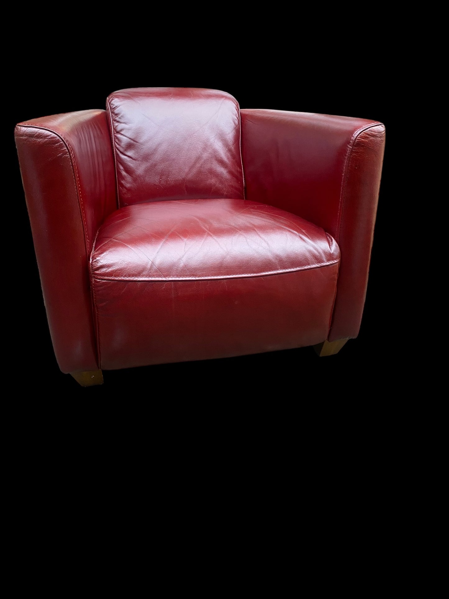 A stunning red leather vintage club chair