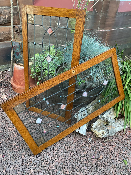 A pair of oak framed leaded stained glass panels circa 1900’s