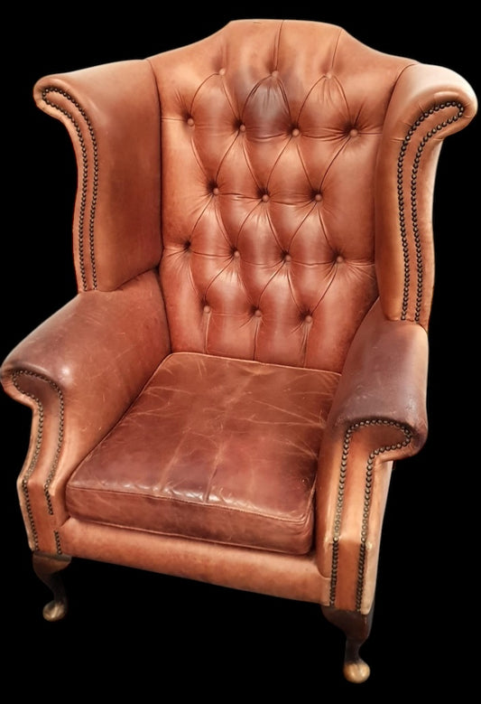 Vintage brown leather wing back armchair with stud detail and raised on front cabriole, queen Anne style  supports