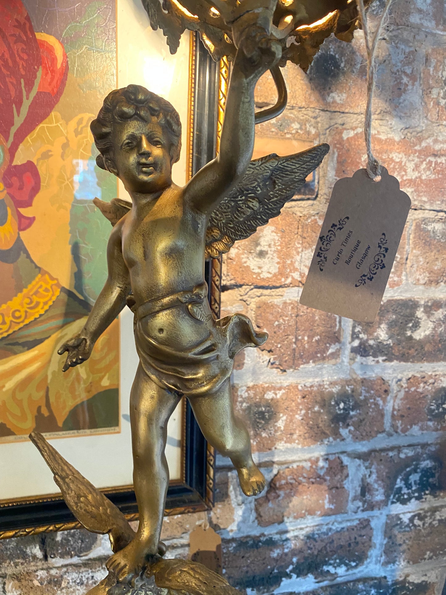 Vintage table lamp in brass with a cherub holding a lantern over an eagle