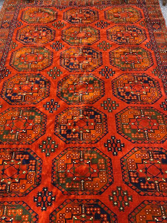 A stunning Turkoman Kerki rug with motif decoration on an orange ground, 275 x 165cm (including fringe)