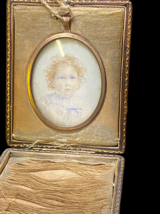 Miniature portrait of a child in rolled gold frame