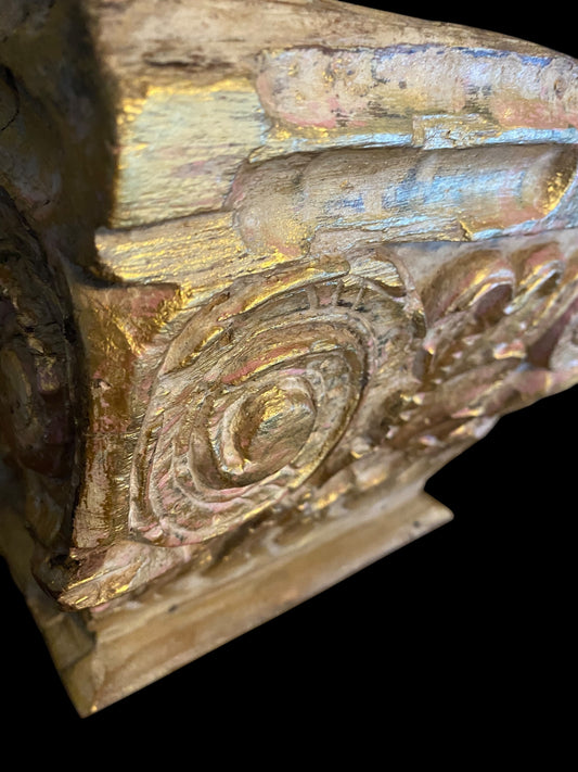 An antique oak corinthian column capital