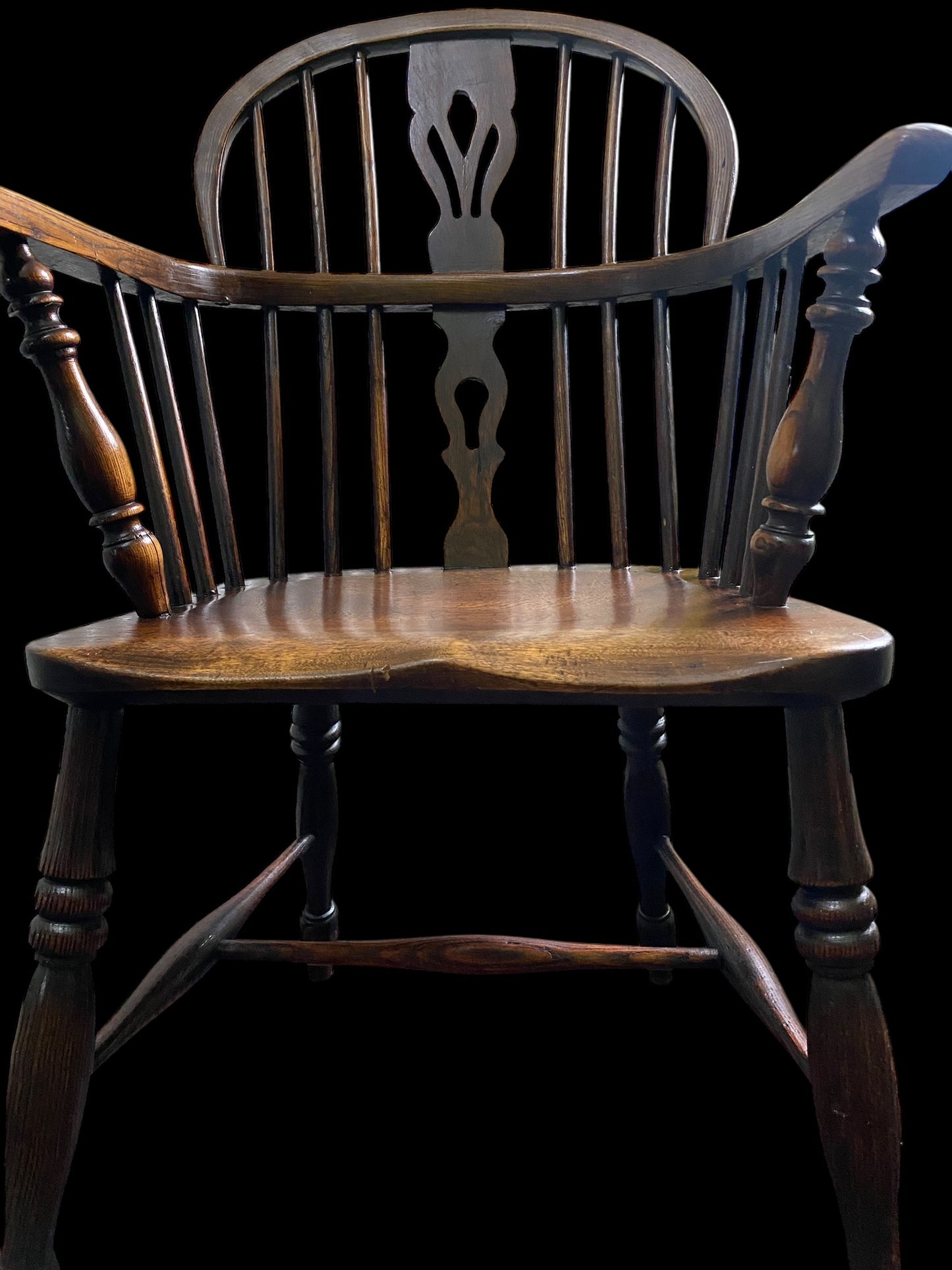 An early Victorian Ash & Elm comb back Windsor chair with carved splat